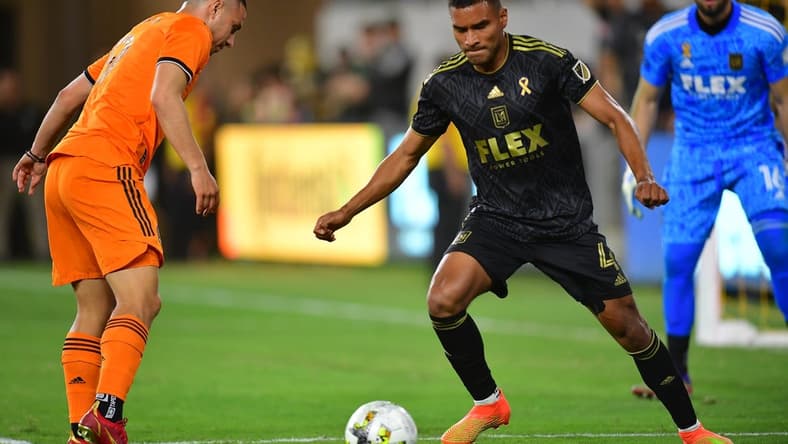 Sep 18, 2022; Los Angeles, California, USA; Los Angeles FC defender Eddie Segura (4) moves the ball against Houston Dynamo forward Sebastian Ferreira (9) during the first half at Banc of California Stadium. Mandatory Credit: Gary A. Vasquez-USA TODAY Sports