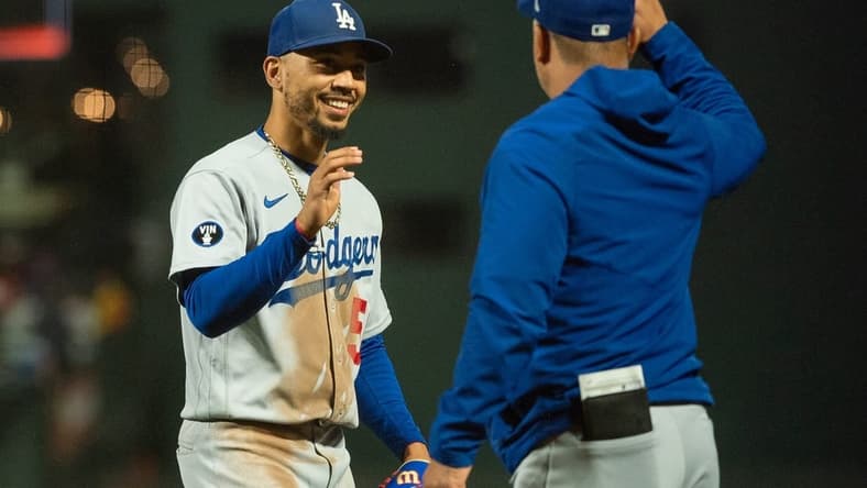 Sep 18, 2022; San Francisco, California, USA;  Los Angeles Dodgers right fielder Mookie Betts (50) celebrates with a team mate after defeating the San Francisco Giants at Oracle Park. Mandatory Credit: Ed Szczepanski-USA TODAY Sports