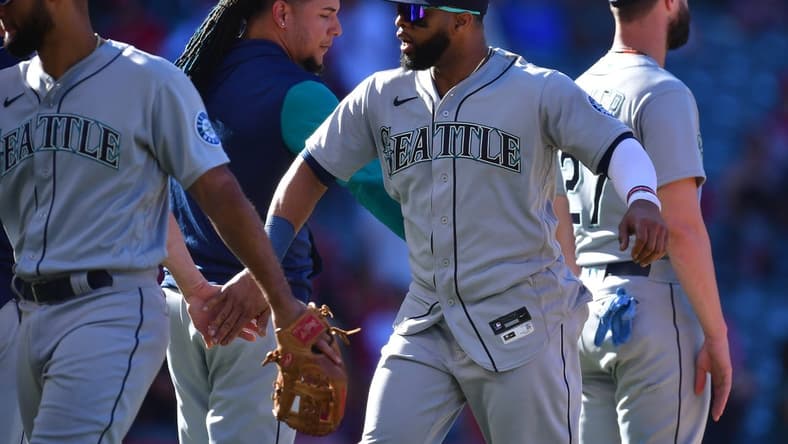 Sep 19, 2022; Anaheim, California, USA; Seattle Mariners designated hitter Carlos Santana (41) celebrates the victory against the Los Angeles Angels at Angel Stadium. Mandatory Credit: Gary A. Vasquez-USA TODAY Sports