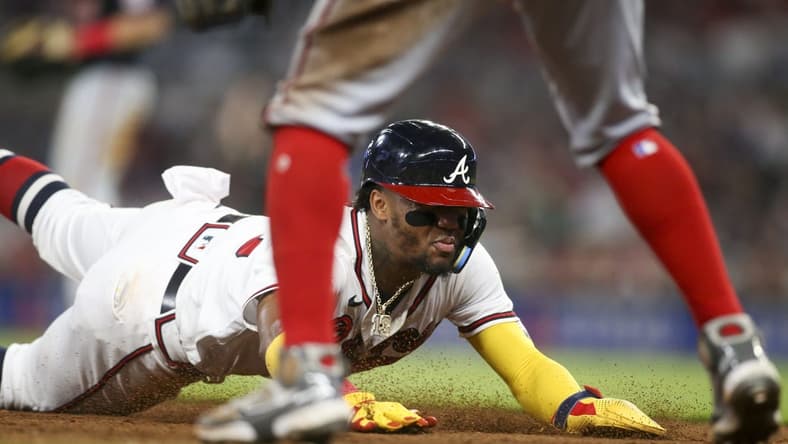 Sep 19, 2022; Atlanta, Georgia, USA; Atlanta Braves right fielder Ronald Acuna Jr. (13) slides in safely at third base against the Washington Nationals in the fifth inning at Truist Park. Mandatory Credit: Brett Davis-USA TODAY Sports
