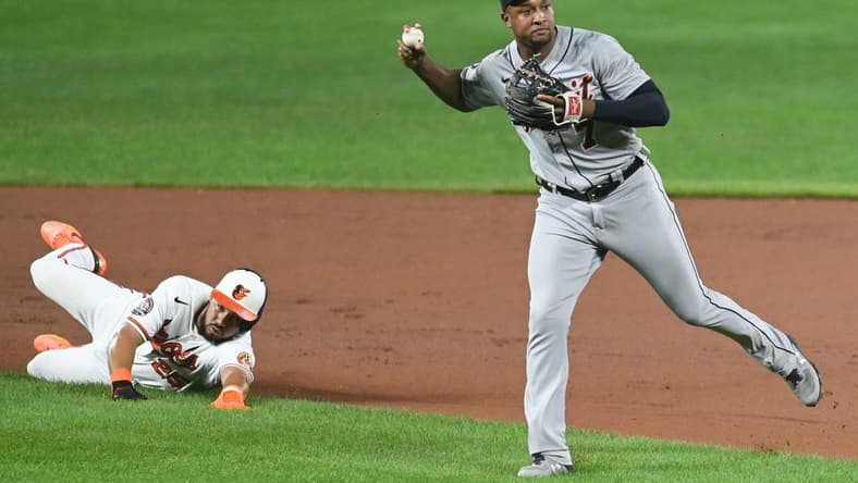 Sep 19, 2022; Baltimore, Maryland, USA; Detroit Tigers second baseman Jonathan Schoop (7) throws to first base after tagging out Baltimore Orioles right fielder Anthony Santander (25) in the seventh inning  at Oriole Park at Camden Yards. Mandatory Credit: Tommy Gilligan-USA TODAY Sports