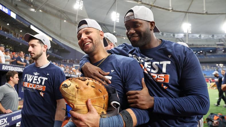 Sep 19, 2022; St. Petersburg, Florida, USA; Houston Astros first baseman Yuli Gurriel (10) and left fielder Yordan Alvarez (44) celebrate after winning the American League West division at Tropicana Field. Mandatory Credit: Nathan Ray Seebeck-USA TODAY Sports