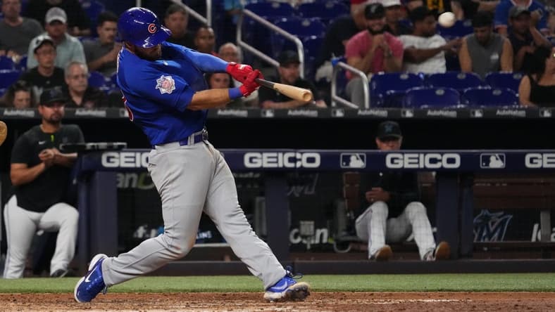 Sep 20, 2022; Miami, Florida, USA; Chicago Cubs third baseman David Bote (13) connects for a solo home run in the seventh inning against the Miami Marlins at loanDepot park. Mandatory Credit: Jasen Vinlove-USA TODAY Sports