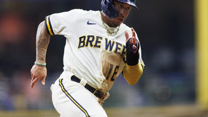 Sep 20, 2022; Milwaukee, Wisconsin, USA; Milwaukee Brewers second baseman Kolten Wong (16) rounds third base before scoring a run during the second inning against the New York Mets at American Family Field. Mandatory Credit: Jeff Hanisch-USA TODAY Sports