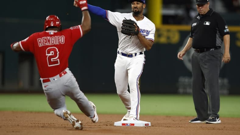 Sep 20, 2022; Arlington, Texas, USA; Texas Rangers second baseman Marcus Semien (2) turns a double play on Los Angeles Angels second baseman Luis Rengifo (2) in the first inning at Globe Life Field. Mandatory Credit: Tim Heitman-USA TODAY Sports