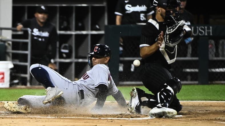 Sep 20, 2022; Chicago, Illinois, USA; Cleveland Guardians second baseman Andres Gimenez (0) scores past Chicago White Sox catcher Seby Zavala (44) during the second inning at Guaranteed Rate Field. Mandatory Credit: Matt Marton-USA TODAY Sports