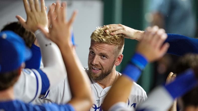 Sep 20, 2022; Kansas City, Missouri, USA; Kansas City Royals first baseman Hunter Dozier (17) is congratulated by teammates after hitting a home run during the fifth inning against the Minnesota Twins at Kauffman Stadium. Mandatory Credit: Jay Biggerstaff-USA TODAY Sports