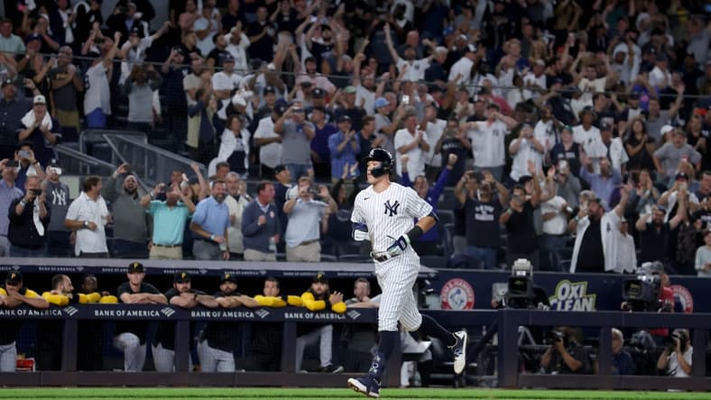 Sep 20, 2022; Bronx, New York, USA; New York Yankees right fielder Aaron Judge (99) rounds the bases after hitting his 60th home run of the season during the ninth inning against the Pittsburgh Pirates at Yankee Stadium. Mandatory Credit: Brad Penner-USA TODAY Sports