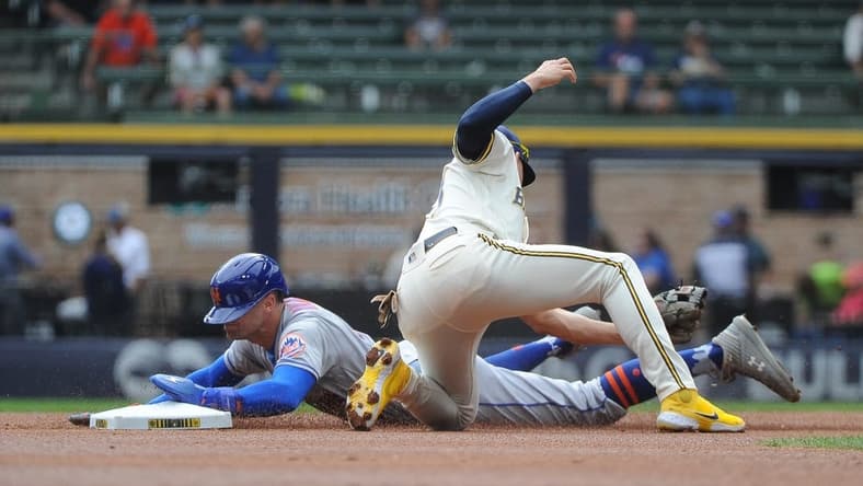 Sep 21, 2022; Milwaukee, Wisconsin, USA; New York Mets center fielder Brandon Nimmo (9) slides into second base safely ahead of the tag from Milwaukee Brewers shortstop Willy Adames (27) in the first inning at American Family Field. Mandatory Credit: Michael McLoone-USA TODAY Sports