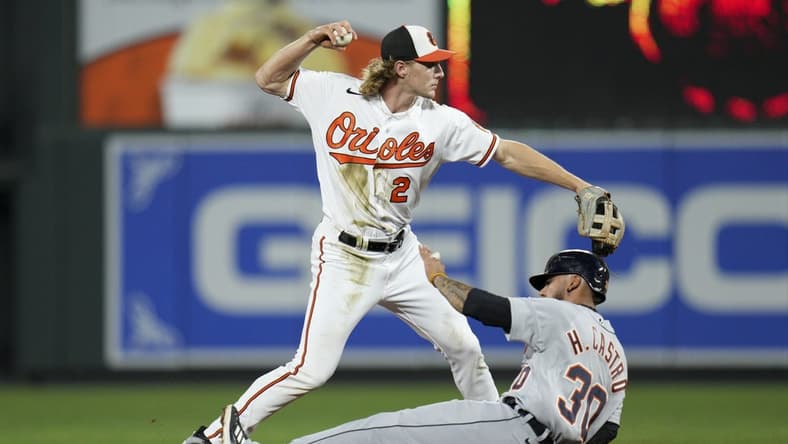 Sep 21, 2022; Baltimore, Maryland, USA; Baltimore Orioles shortstop Gunnar Henderson (2) throws to first base for a double play as Detroit Tigers second baseman Harold Castro (30) slides into second base during the second inning at Oriole Park at Camden Yards. Mandatory Credit: Jessica Rapfogel-USA TODAY Sports