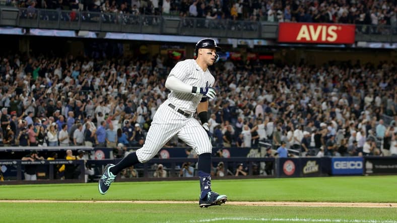 Sep 21, 2022; Bronx, New York, USA; New York Yankees right fielder Aaron Judge (99) runs to first base after hitting a ground rule double against the Pittsburgh Pirates during the fifth inning at Yankee Stadium. Mandatory Credit: Brad Penner-USA TODAY Sports