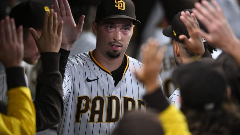 Sep 21, 2022; San Diego, California, USA; San Diego Padres starting pitcher Blake Snell (4) is greeted in the dugout after completing the top of the seventh inning against the St. Louis Cardinals at Petco Park. Mandatory Credit: Orlando Ramirez-USA TODAY Sports