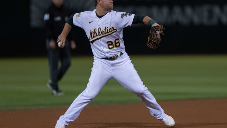 Sep 21, 2022; Oakland, California, USA; Oakland Athletics third baseman Sheldon Neuse (26) throws the baseball during the seventh inning against the Seattle Mariners at RingCentral Coliseum. Mandatory Credit: Stan Szeto-USA TODAY Sports