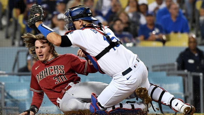 Sep 21, 2022; Los Angeles, California, USA; Arizona Diamondbacks left fielder Jake McCarthy (30) scores in front of Los Angeles Dodgers catcher Austin Barnes (15) during the 7th inning at Dodger Stadium. Mandatory Credit: Richard Mackson-USA TODAY Sports