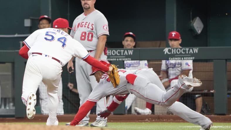 Sep 22, 2022; Arlington, Texas, USA; Texas Rangers starting pitcher Martin Perez (54) tags out Los Angeles Angels center fielder Magneuris Sierra (37) during the fourth inning at Globe Life Field. Mandatory Credit: Jim Cowsert-USA TODAY Sports