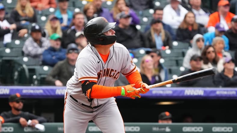Sep 22, 2022; Denver, Colorado, USA; San Francisco Giants left fielder Joc Pederson (23) singles in the sixth inning against the Colorado Rockies at Coors Field. Mandatory Credit: Ron Chenoy-USA TODAY Sports