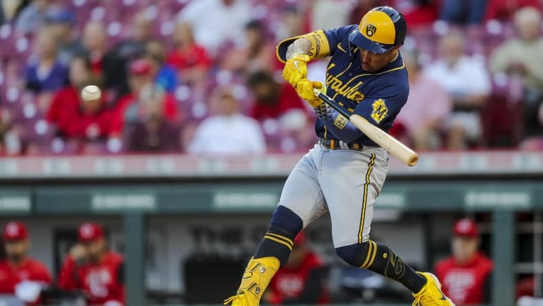 Sep 22, 2022; Cincinnati, Ohio, USA; Milwaukee Brewers second baseman Kolten Wong (16) hits a two-run home run in the second inning against the Cincinnati Reds at Great American Ball Park. Mandatory Credit: Katie Stratman-USA TODAY Sports