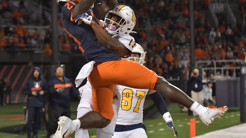 Sep 22, 2022; Champaign, Illinois, USA; Illinois Fighting Illini defensive back Jartavius Martin (21) intercepts the ball in the end zone on a pass intended for Chattanooga Mocs wide receiver Tyron Arnett (13) during the first half at Memorial Stadium. Mandatory Credit: Ron Johnson-USA TODAY Sports