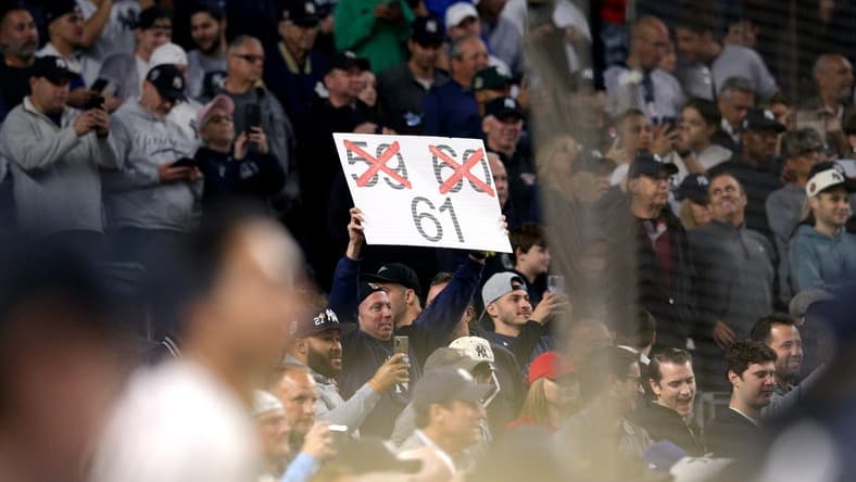 Sep 22, 2022; Bronx, New York, USA; A fan holds a sign as New York Yankees right fielder Aaron Judge (not pictured) bats against the Boston Red Sox during the ninth inning at Yankee Stadium. Mandatory Credit: Brad Penner-USA TODAY Sports