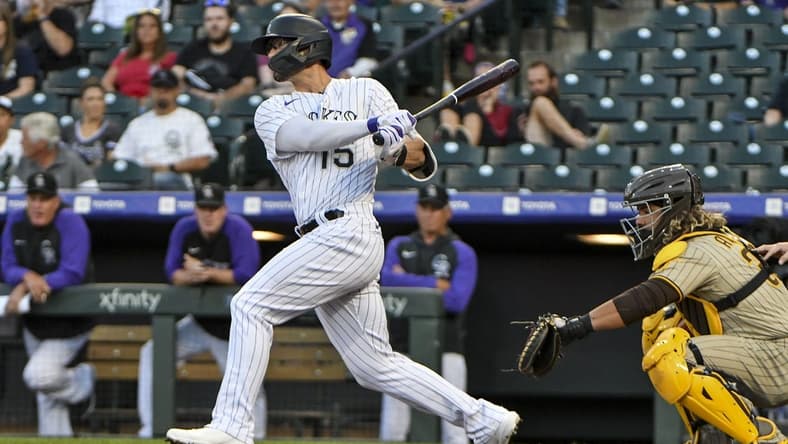 Sep 23, 2022; Denver, Colorado, USA; Colorado Rockies right fielder Randal Grichuk (15) hits a single during the first inning against the San Diego Padres at Coors Field. Mandatory Credit: John Leyba-USA TODAY Sports
