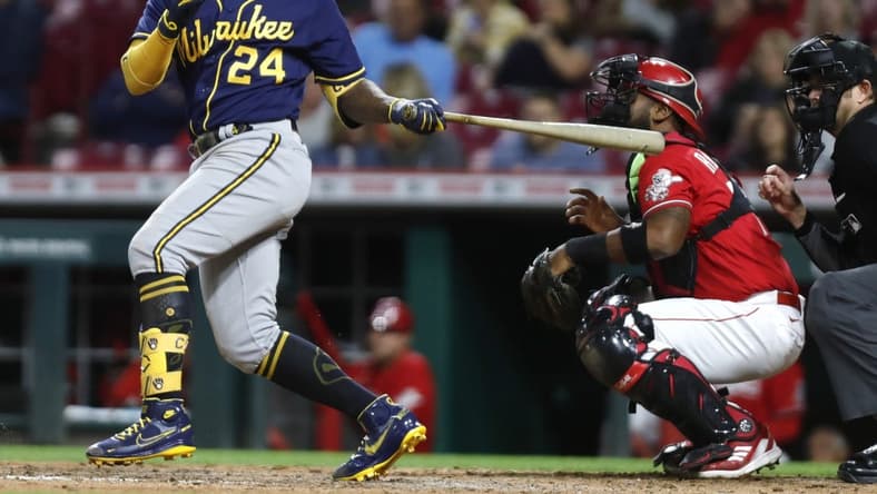 Sep 23, 2022; Cincinnati, Ohio, USA; Milwaukee Brewers designated hitter Andrew McCutchen (24) hits a two-RBI double against the Cincinnati Reds during the seventh inning at Great American Ball Park. Mandatory Credit: David Kohl-USA TODAY Sports