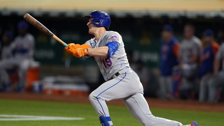 Sep 23, 2022; Oakland, California, USA; New York Mets left fielder Mark Canha (19) hits a double against the Oakland Athletics during the eighth inning at RingCentral Coliseum. Mandatory Credit: Darren Yamashita-USA TODAY Sports