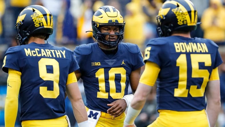 Michigan quarterbacks Alex Orji (10), J.J. McCarthy (9) and quarterback Alan Bowman warm up ahead of the Maryland game at Michigan Stadium in Ann Arbor on Saturday, Sept. 24, 2022.