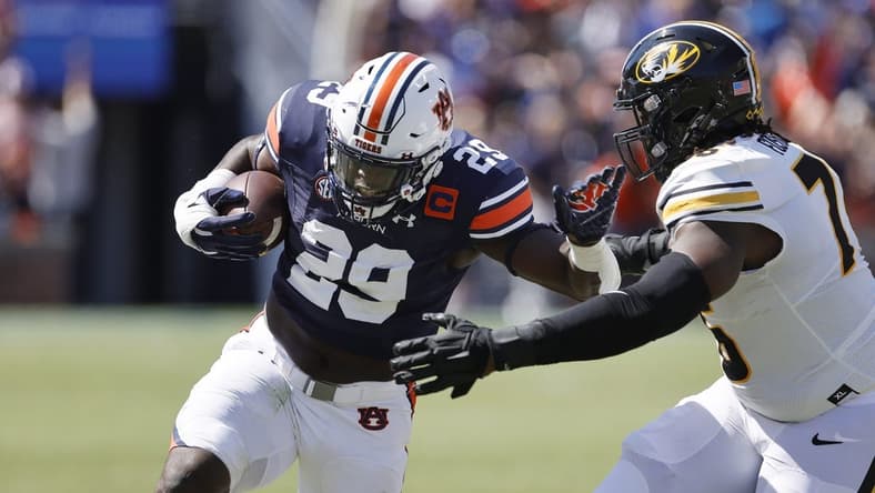 Sep 24, 2022; Auburn, Alabama, USA;  Auburn Tigers linebacker Derick Hall (29) returns an interception as Missouri Tigers offensive lineman Javon Foster (76) goes for the tackle during the first quarter at Jordan-Hare Stadium. Mandatory Credit: John Reed-USA TODAY Sports