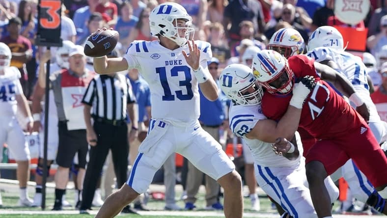 Sep 24, 2022; Lawrence, Kansas, USA; Duke Blue Devils quarterback Riley Leonard (13) throws a pass against the Kansas Jayhawks during the first half of the game at David Booth Kansas Memorial Stadium. Mandatory Credit: Denny Medley-USA TODAY Sports