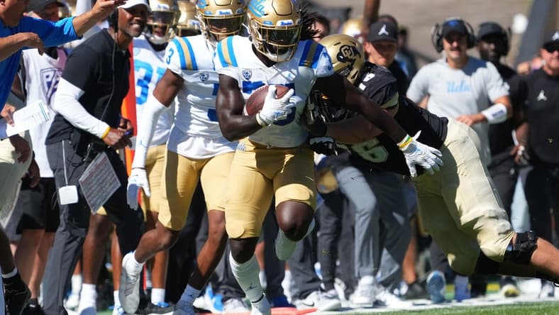 Sep 24, 2022; Boulder, Colorado, USA; UCLA Bruins linebacker Carl Jones Jr. (35) returns a  interception in the third quarter against the Colorado Buffaloes at Folsom Field. Mandatory Credit: Ron Chenoy-USA TODAY Sports