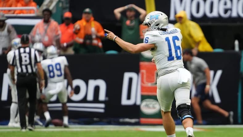 Sep 24, 2022; Miami Gardens, Florida, USA; Middle Tennessee Blue Raiders quarterback Chase Cunningham (16) celebrates after throwing a touchdown pass against the Miami Hurricanes during the first half at Hard Rock Stadium. Mandatory Credit: Jasen Vinlove-USA TODAY Sports