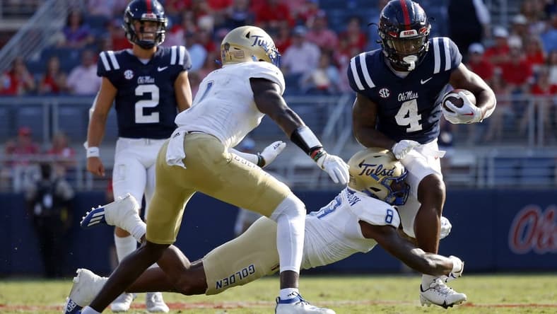 Sep 24, 2022; Oxford, Mississippi, USA; Mississippi Rebels running back Quinshon Judkins (4) runs the ball as Tulsa Golden Hurricane linebacker Brian Johnson (8) attempts to make the tackle during the first half at Vaught-Hemingway Stadium. Mandatory Credit: Petre Thomas-USA TODAY Sports