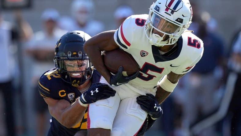 Sep 24, 2022; Berkeley, California, USA; Arizona Wildcats wide receiver Dorian Singer (5) is tackled by California Golden Bears safety Daniel Scott (32) during the second quarter at FTX Field at California Memorial Stadium. Mandatory Credit: Darren Yamashita-USA TODAY Sports
