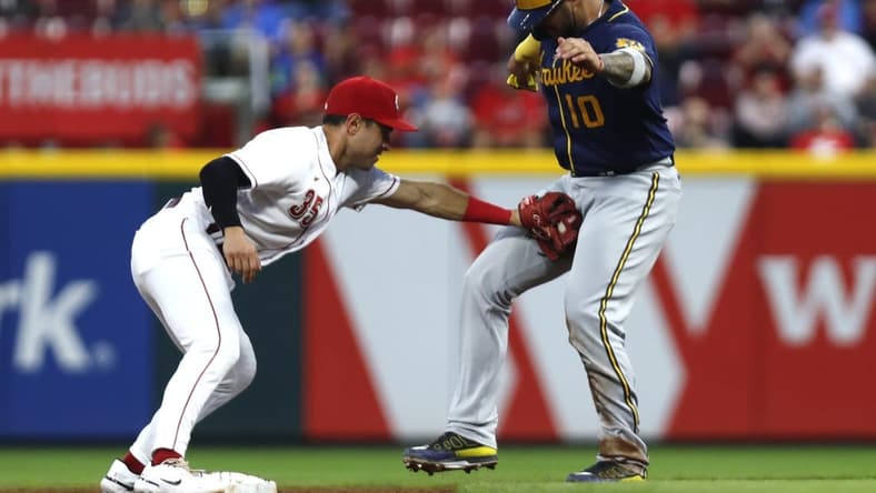 Sep 24, 2022; Cincinnati, Ohio, USA; Milwaukee Brewers catcher Omar Narvaez (10) is tagged out by Cincinnati Reds second baseman Alejo Lopez (35) during the third inning at Great American Ball Park. Mandatory Credit: David Kohl-USA TODAY Sports