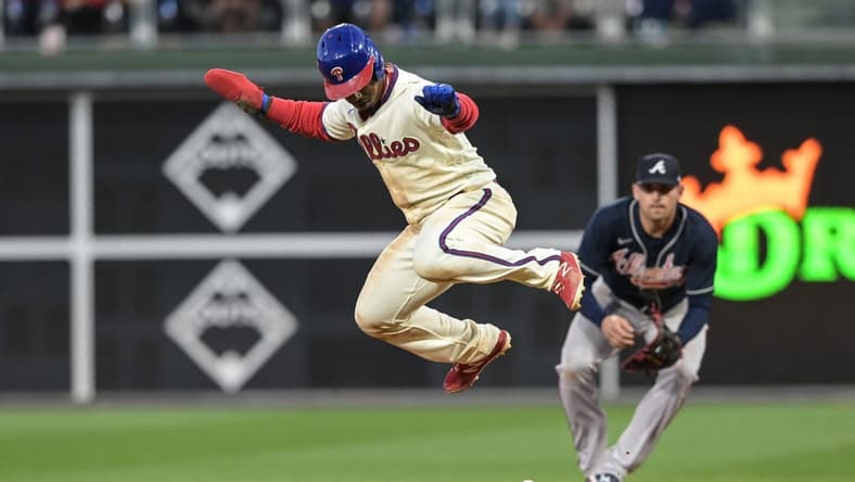 Sep 24, 2022; Philadelphia, Pennsylvania, USA; Philadelphia Phillies second baseman Jean Segura (2) jumps to avoid a ball hit by Philadelphia Phillies shortstop Bryson Stott (not pictured) during the seventh inning of the game against the Atlanta Braves at Citizens Bank Park. The Braves won with a score of 6-3. Mandatory Credit: John Geliebter-USA TODAY Sports