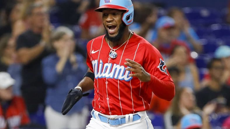 Sep 24, 2022; Miami, Florida, USA; Miami Marlins center fielder Bryan De La Cruz (14) scores after a double by shortstop Miguel Rojas (not pictured) during the sixth inning against the Washington Nationals at loanDepot Park. Mandatory Credit: Sam Navarro-USA TODAY Sports