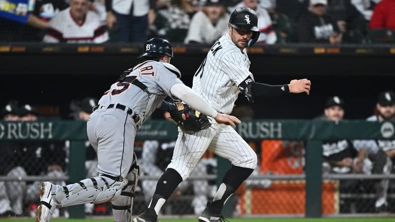 Sep 24, 2022; Chicago, Illinois, USA; Chicago White Sox outfielder AJ Pollock (18) is tagged out along the third base line by Detroit Tigers catcher Tucker Barnhart (15) after trying to score on an infield hit in the fourth inning at Guaranteed Rate Field. Mandatory Credit: Jamie Sabau-USA TODAY Sports
