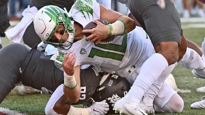 Sep 24, 2022; Pullman, Washington, USA; Oregon Ducks quarterback Bo Nix (10) is stopped short of the goalie by Washington State Cougars linebacker Travion Brown (82) in the second half at Gesa Field at Martin Stadium. Ducks won 44-41. Mandatory Credit: James Snook-USA TODAY Sports