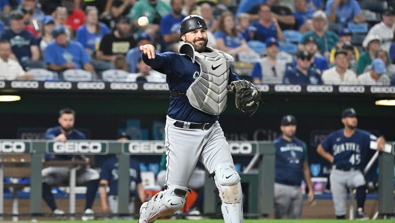 Sep 24, 2022; Kansas City, Missouri, USA; Seattle Mariners catcher Curt Casali (5) throws to first base for an out during the fourth inning against the Kansas City Royals at Kauffman Stadium. Mandatory Credit: Peter Aiken-USA TODAY Sports