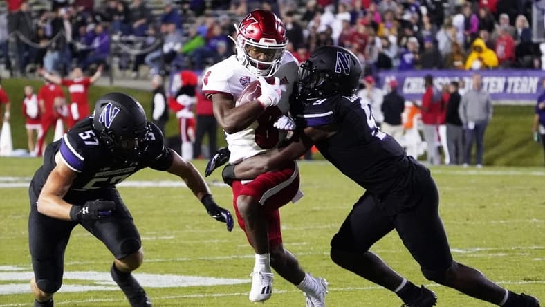 Sep 24, 2022; Evanston, Illinois, USA; Northwestern Wildcats defensive back Jeremiah Lewis (9) tackles Miami (Ohio) Redhawks running back Kevin Davis (8) during the first half at Ryan Field. Mandatory Credit: David Banks-USA TODAY Sports