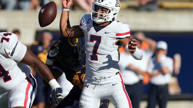 Sep 24, 2022; Berkeley, California, USA; Arizona Wildcats quarterback Jayden de Laura (7) fumbles after being hit by California Golden Bears linebacker Orin Patu (48) during the third quarter at FTX Field at California Memorial Stadium. Mandatory Credit: Darren Yamashita-USA TODAY Sports