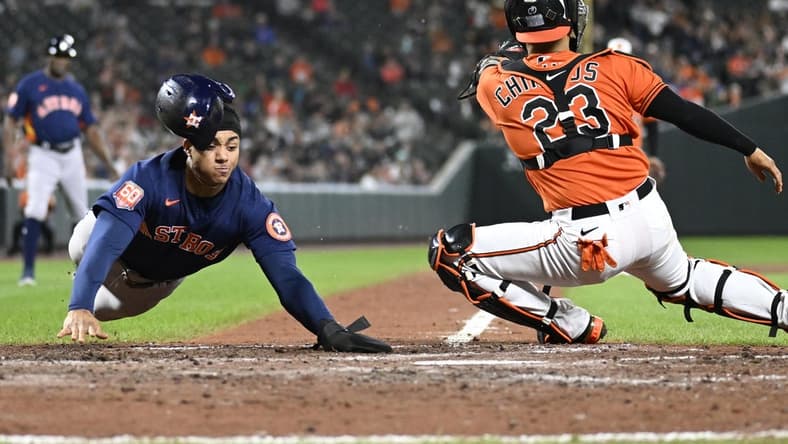 Sep 24, 2022; Baltimore, Maryland, USA;  Houston Astros shortstop Jeremy Pena (3) slides safely into home plate against the Baltimore Orioles during the fifth inning at Oriole Park at Camden Yards. Mandatory Credit: James A. Pittman-USA TODAY Sports