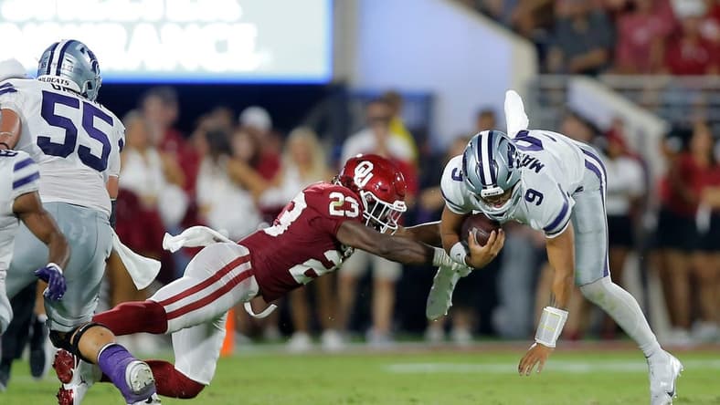 Oklahoma's DaShaun White (23) brings down Kansas State's Adrian Martinez (9) during a college football game between the University of Oklahoma Sooners (OU) and the Kansas State Wildcats at Gaylord Family - Oklahoma Memorial Stadium in Norman, Okla., Saturday, Sept. 24, 2022.
Ou Vs Kansas State