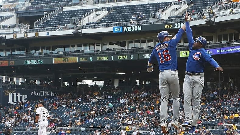 Sep 25, 2022; Pittsburgh, Pennsylvania, USA; Chicago Cubs third baseman Patrick Wisdom (16) celebrates with third base coach Willie Harris (33) after hitting a three-run home run against Pittsburgh Pirates relief pitcher Manny Banuelos (53) during the fifth inning at PNC Park. Mandatory Credit: Charles LeClaire-USA TODAY Sports