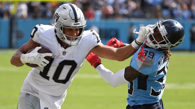 Sep 25, 2022; Nashville, Tennessee, USA; Las Vegas Raiders wide receiver Mack Hollins (10) pushes off on a tackle attempt by Tennessee Titans cornerback Terrance Mitchell (39) during the second half at Nissan Stadium. Mandatory Credit: Christopher Hanewinckel-USA TODAY Sports