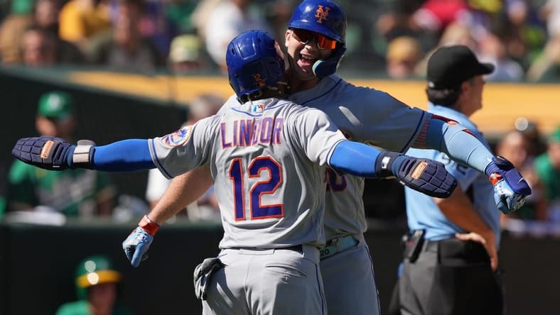 Sep 25, 2022; Oakland, California, USA; New York Mets designated hitter Pete Alonso (right) celebrates with shortstop Francisco Lindor (12) after hitting a home run against the Oakland Athletics during the fourth inning at RingCentral Coliseum. Mandatory Credit: Darren Yamashita-USA TODAY Sports