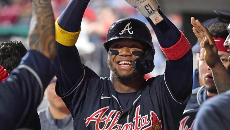 Sep 25, 2022; Philadelphia, Pennsylvania, USA; Atlanta Braves right fielder Ronald Acuna Jr. (13) celebrates in the dugout against the Philadelphia Phillies during the eleventh inning at Citizens Bank Park. Mandatory Credit: Eric Hartline-USA TODAY Sports