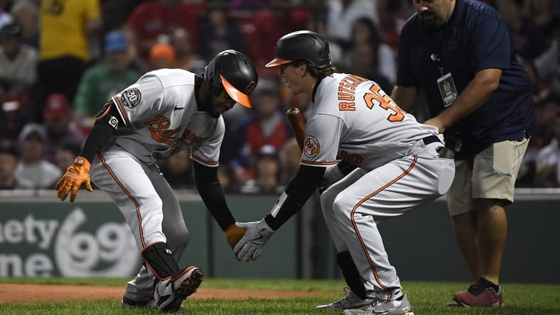 Sep 26, 2022; Boston, Massachusetts, USA; Baltimore Orioles center fielder Cedric Mullins (left) celebrates his home run with catcher Adley Rutschman (35) during the first inning against the Boston Red Sox at Fenway Park. Mandatory Credit: Bob DeChiara-USA TODAY Sports