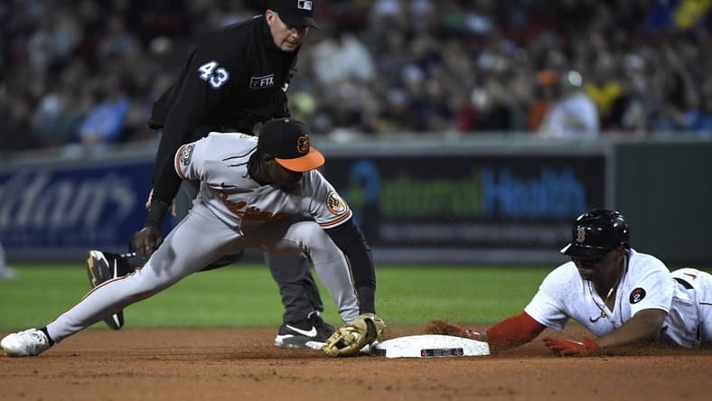 Sep 26, 2022; Boston, Massachusetts, USA; Boston Red Sox third baseman Rafael Devers (11) slides safely into second base ahead of the tag of Baltimore Orioles shortstop Jorge Mateo (3) during the first inning at Fenway Park. Mandatory Credit: Bob DeChiara-USA TODAY Sports