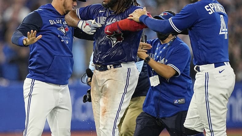 Sep 26, 2022; Toronto, Ontario, CAN; Toronto Blue Jays first baseman Vladimir Guerrero Jr. (center) celebrates after hitting a walk-off single against the New York Yankees during the tenth inning at Rogers Centre. Mandatory Credit: John E. Sokolowski-USA TODAY Sports